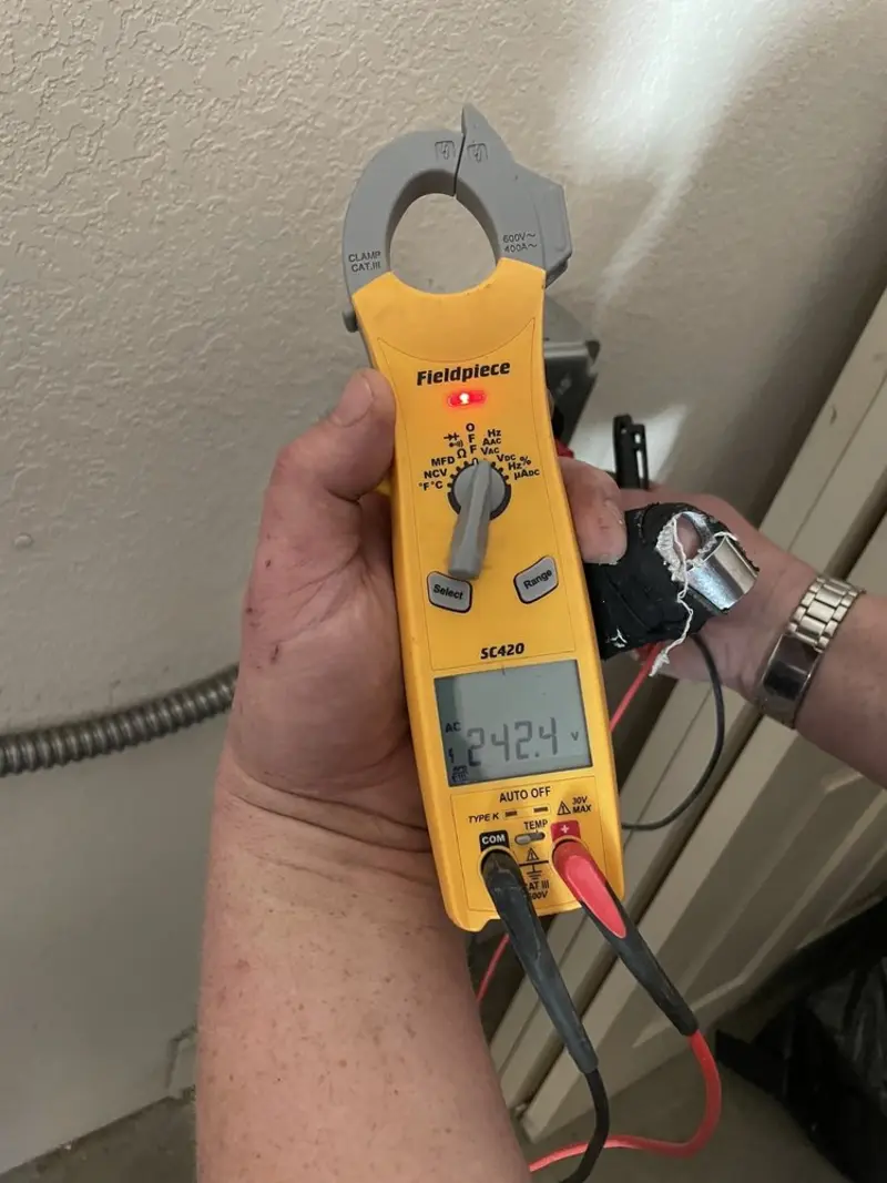 Voltage testing with clamp meter during Whole House Surge Protector in Mountain Grove